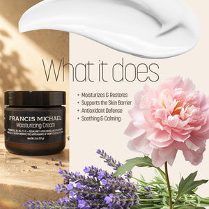 Francis Michael Moisturizing Cream jar shown beside a large white cream smear and text reading 'What it does,' with skincare benefits listed and pink flowers/lavender in the background.