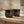 Two jars of Francis Michael skincare products, Francis Michael Exfoliating Paste and Francis Michael Detoxifying Mask, on a wooden surface with a blurred background.