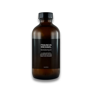 Brown bottle of Francis Michael Revitalizing Oil on a white background