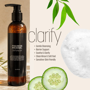 Francis Michael Clarify Cleansing Gel in an amber bottle with a black pump and black label, shown beside product benefits text, green leaves, cucumber slices, and a foam circle on a light beige background.