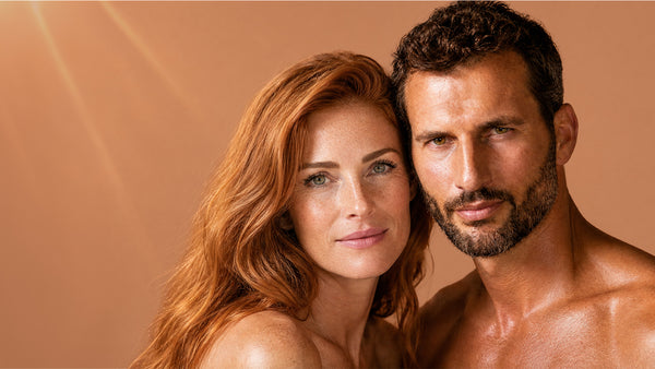 A couple who have used Francis Michael Skincare posing closely against a caramel background